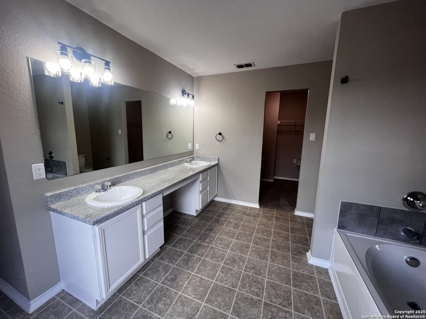 735 Inks Farm San Antonio, TX 78228 - Photo 15 of 17 a bathroom with a sink a toilet and mirror