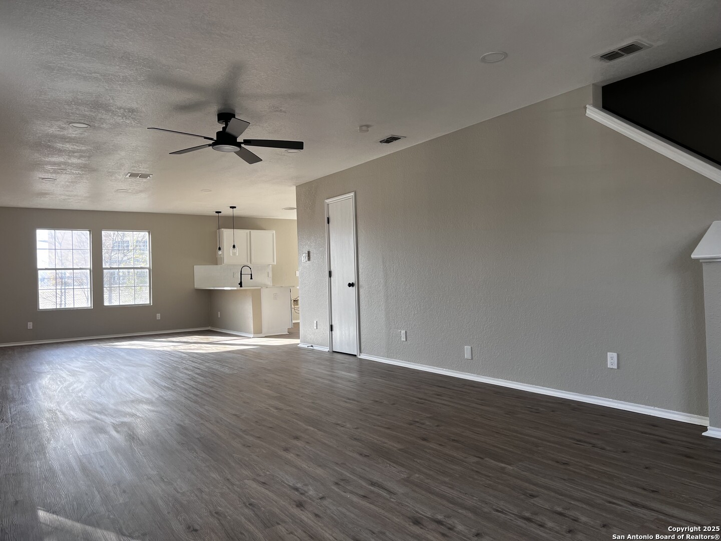 735 Inks Farm San Antonio, TX 78228 - Photo 3 of 17 a view of an empty room with wooden floor and a window