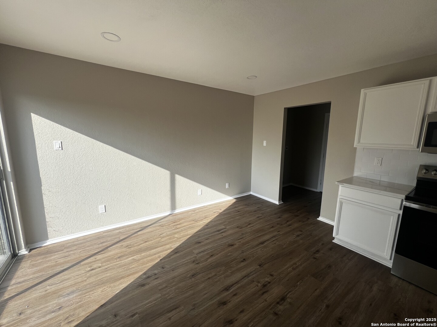 735 Inks Farm San Antonio, TX 78228 - Photo 7 of 17 a view of an empty room with wooden floor and a window