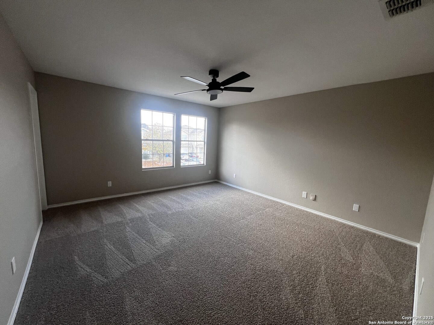 735 Inks Farm San Antonio, TX 78228 - Photo 8 of 17 an empty room with windows and ceiling fan