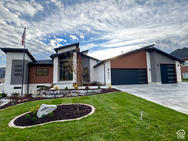655 Willard Peak Road Mantua, UT 84324 - Photo 1 of 1 Modern home featuring an attached garage, new landscaping, and concrete driveway