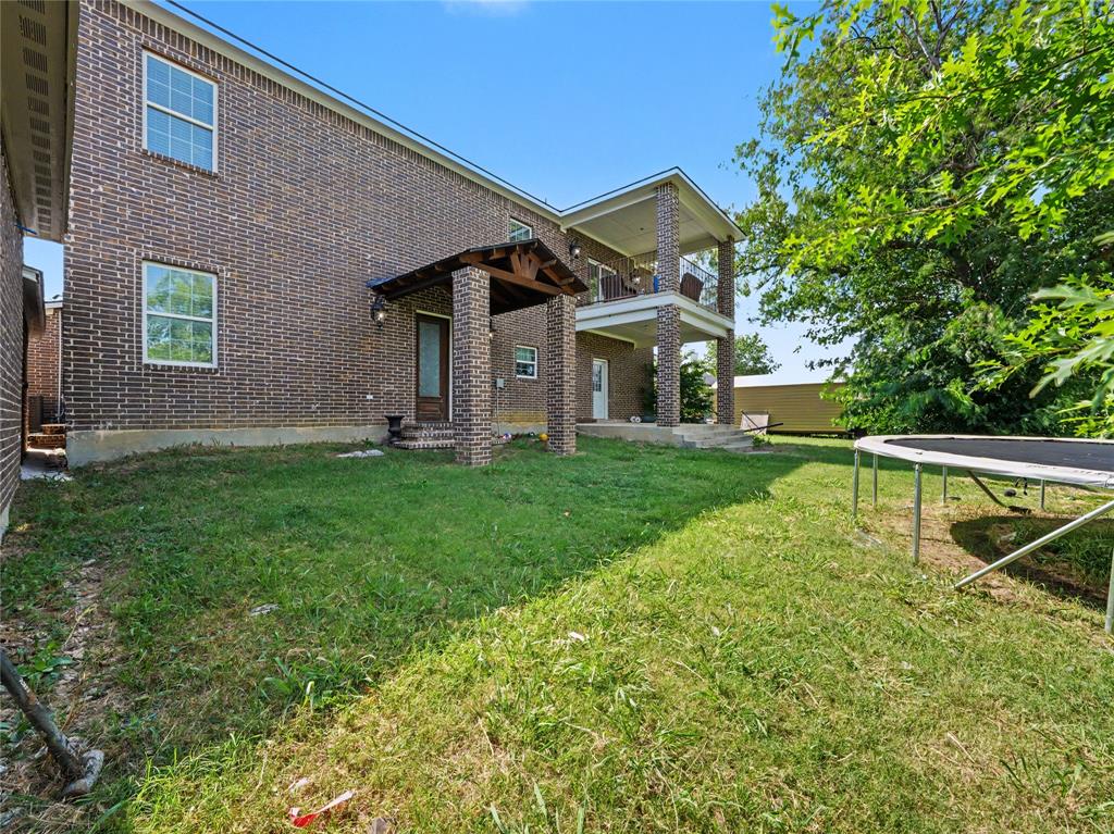 6701 Nauert Road Forest Hill, TX 76140 - Photo 32 of 40 Brick exterior featuring a covered porch with exposed wood beams and a second-story balcony