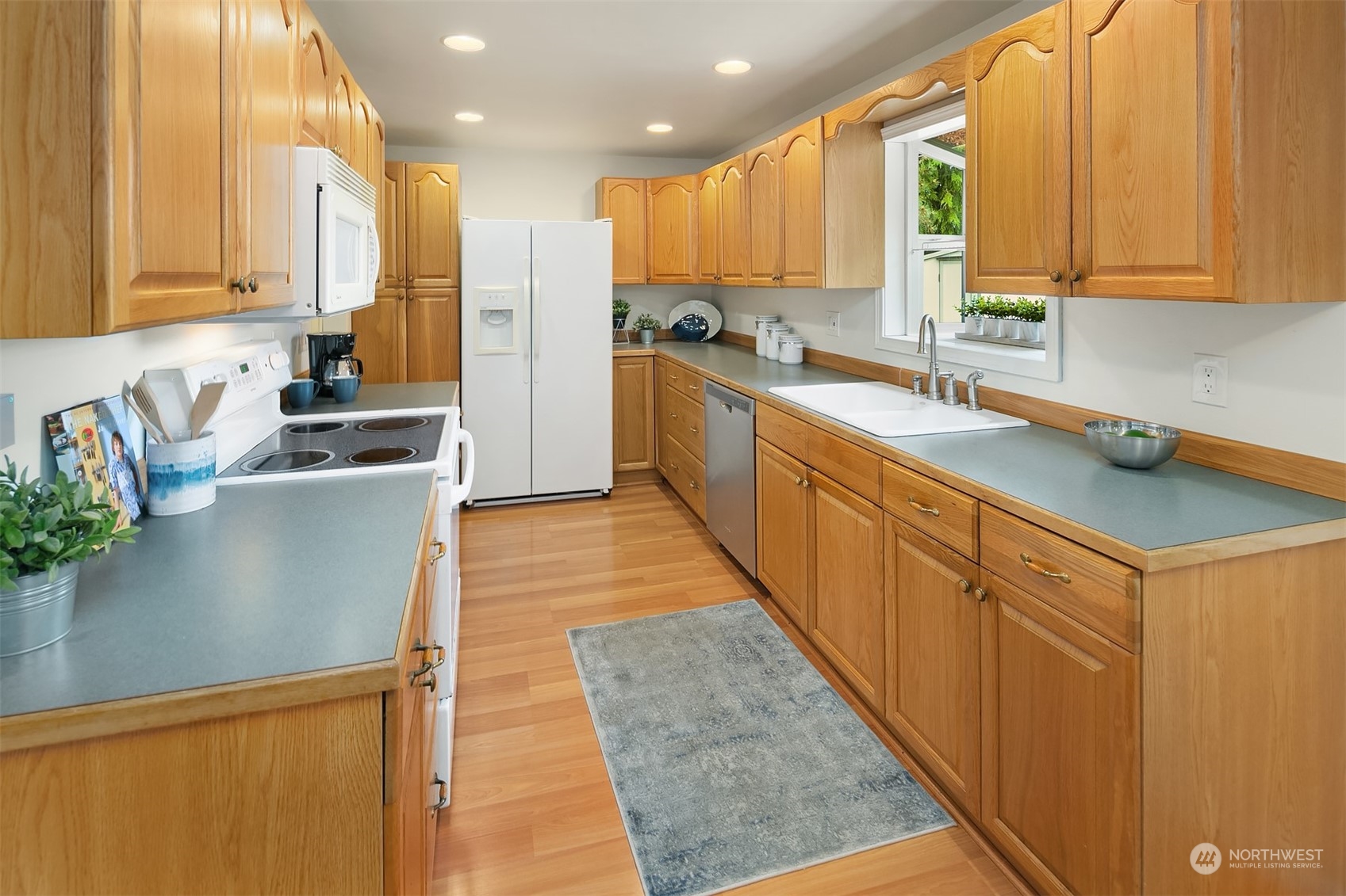 2919 Stafford Way Bothell, WA 98012 - Photo 15 of 30 a kitchen with stainless steel appliances granite countertop a sink a stove and a refrigerator