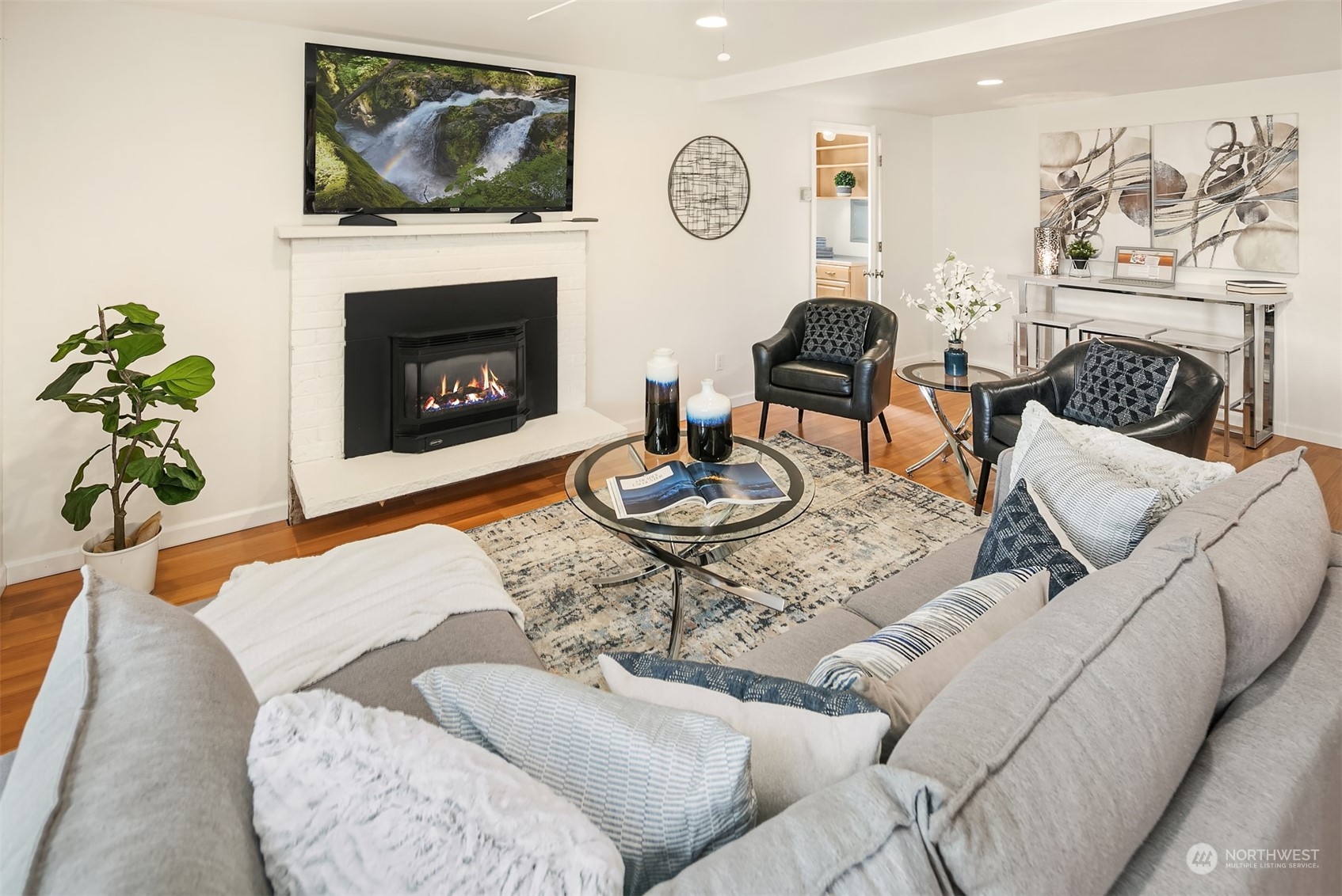 2919 Stafford Way Bothell, WA 98012 - Photo 7 of 30 a living room with furniture a fireplace and a flat screen tv
