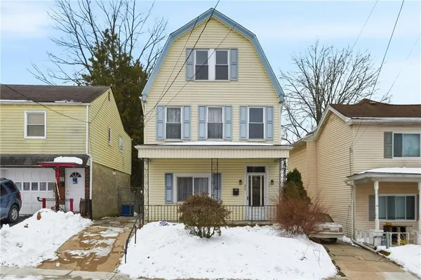 a front view of a house with a yard