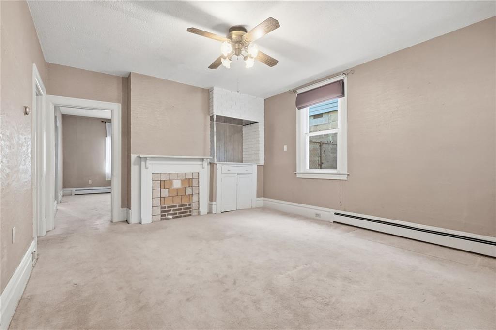 373 Copperfield Avenue Pittsburgh, PA 15210 - Photo 11 of 39 a view of an empty room with chandelier fan and windows