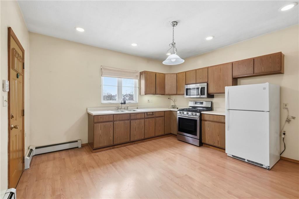 373 Copperfield Avenue Pittsburgh, PA 15210 - Photo 12 of 39 a kitchen with a refrigerator a sink and cabinets