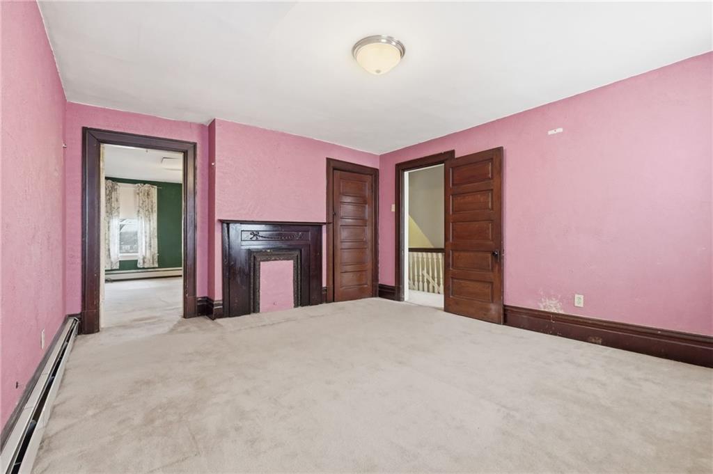 373 Copperfield Avenue Pittsburgh, PA 15210 - Photo 21 of 39 a view of an empty room with a fireplace