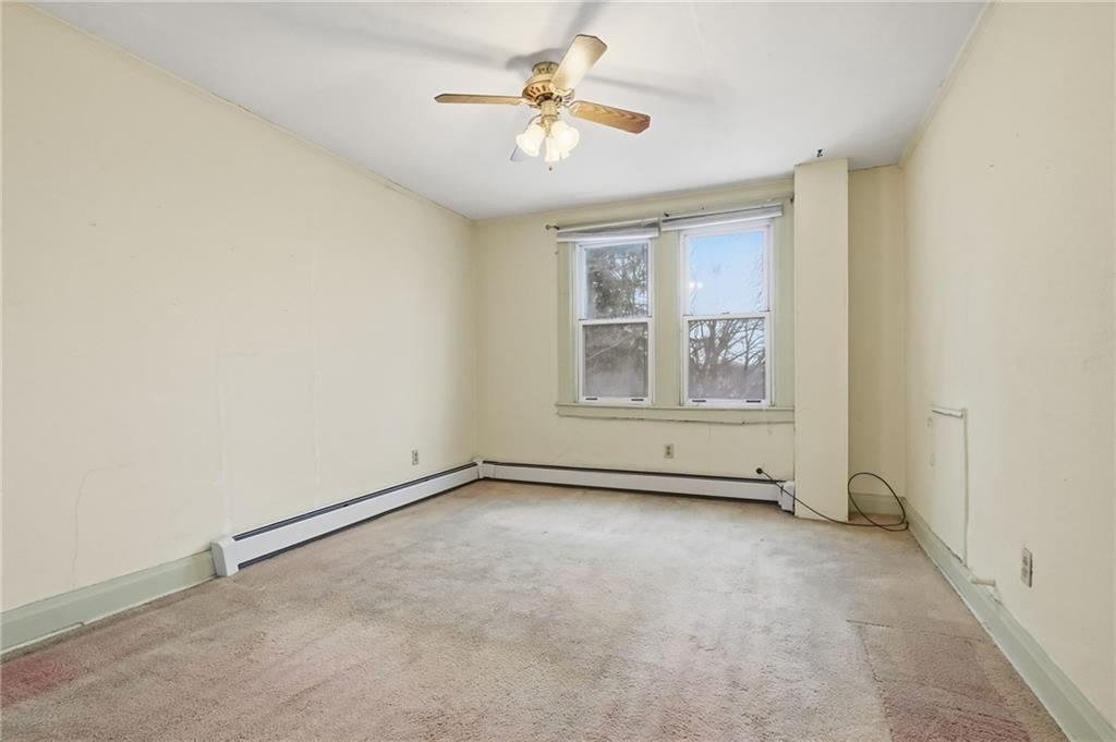 373 Copperfield Avenue Pittsburgh, PA 15210 - Photo 27 of 39 an empty room with windows and fan