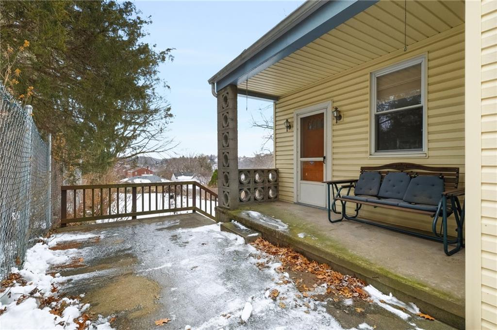 373 Copperfield Avenue Pittsburgh, PA 15210 - Photo 32 of 39 a view of a house with a wooden bench in a patio