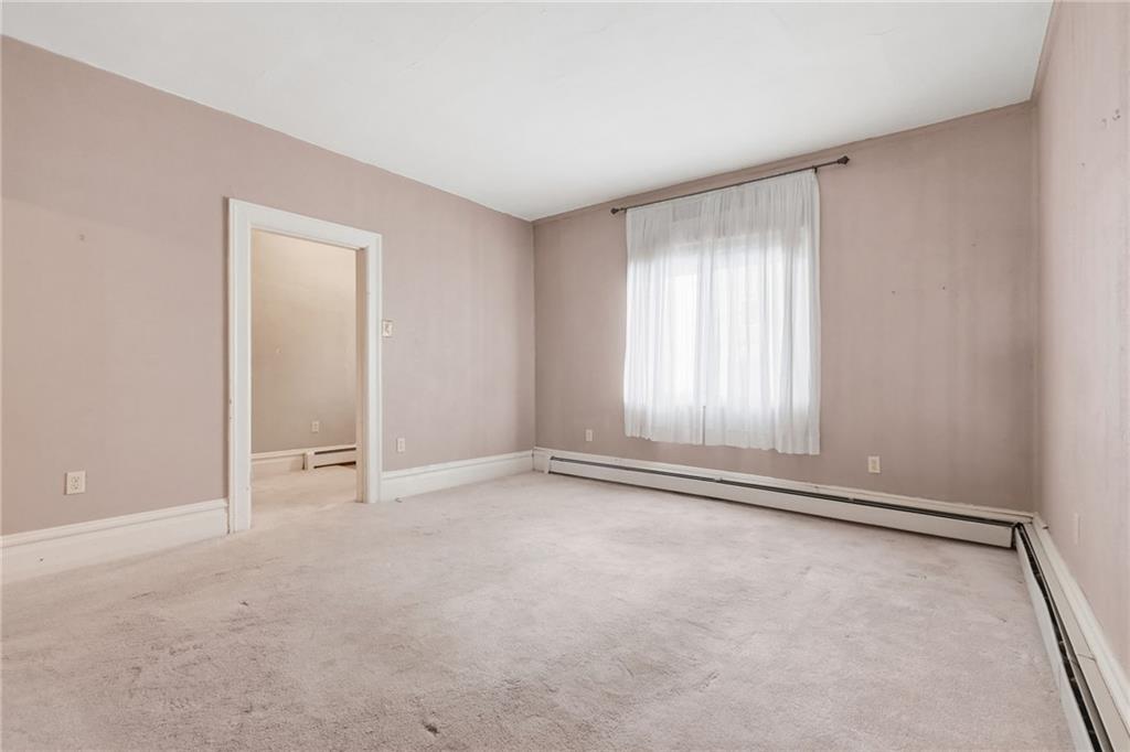 373 Copperfield Avenue Pittsburgh, PA 15210 - Photo 9 of 39 an empty room with windows