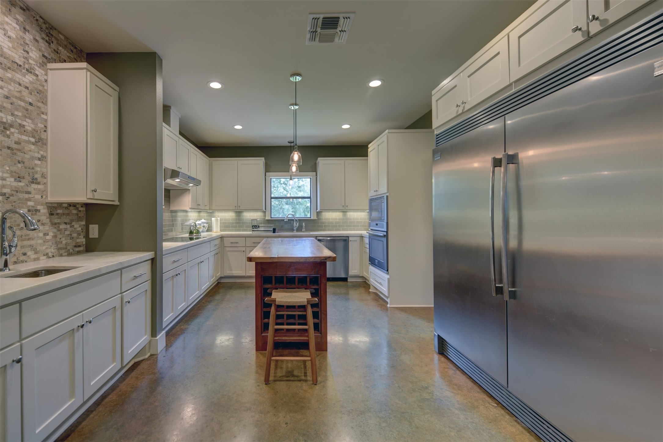 2003 Oak Ridge Road Weimar, TX 78962 - Photo 9 of 35 a kitchen with stainless steel appliances refrigerator cabinets dining table and chairs