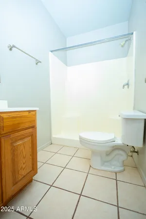 a bathroom with a toilet a sink a mirror and vanity