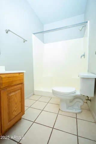 a bathroom with a toilet a sink a mirror and vanity