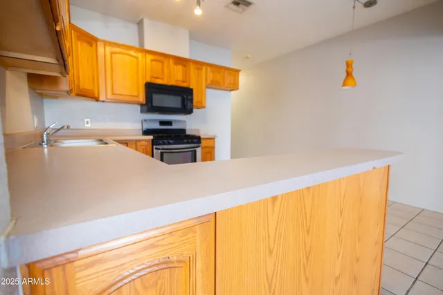 a kitchen with a sink and a microwave