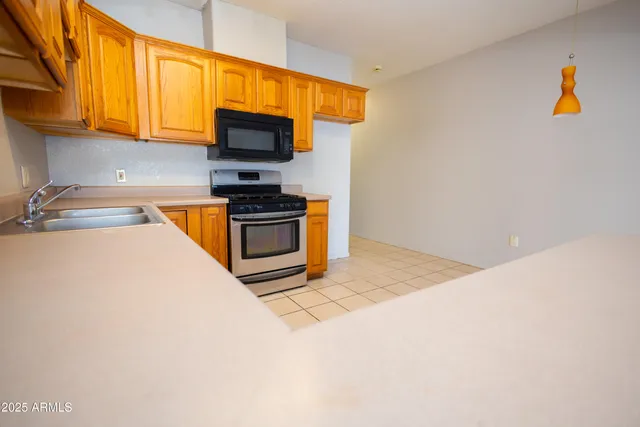 a kitchen with stainless steel appliances a stove a microwave and cabinets