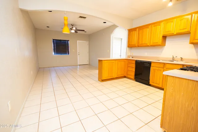 a kitchen with a sink cabinets and window