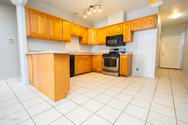 a kitchen with stainless steel appliances a refrigerator sink and microwave