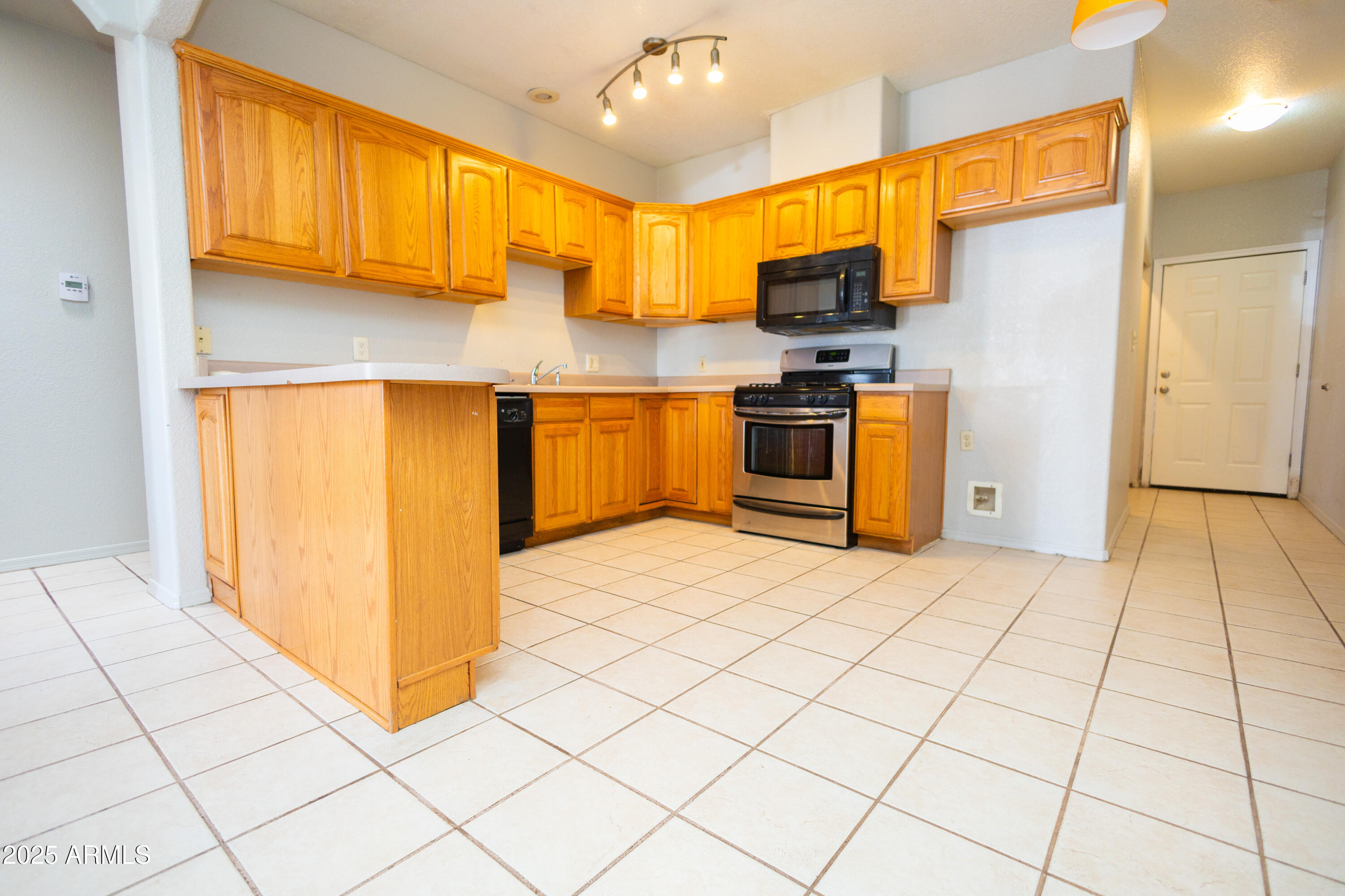 434 North Christine Avenue Douglas, AZ 85607 - Photo 7 of 39 a kitchen with stainless steel appliances a refrigerator sink and microwave