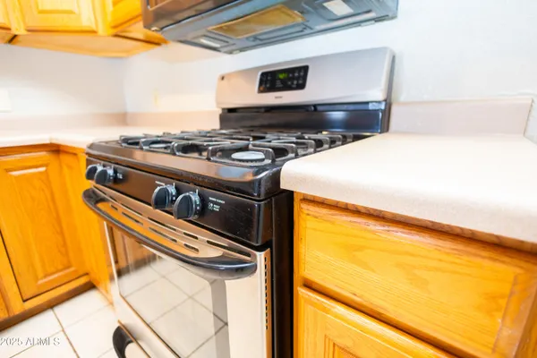a kitchen with stainless steel appliances a stove and a microwave