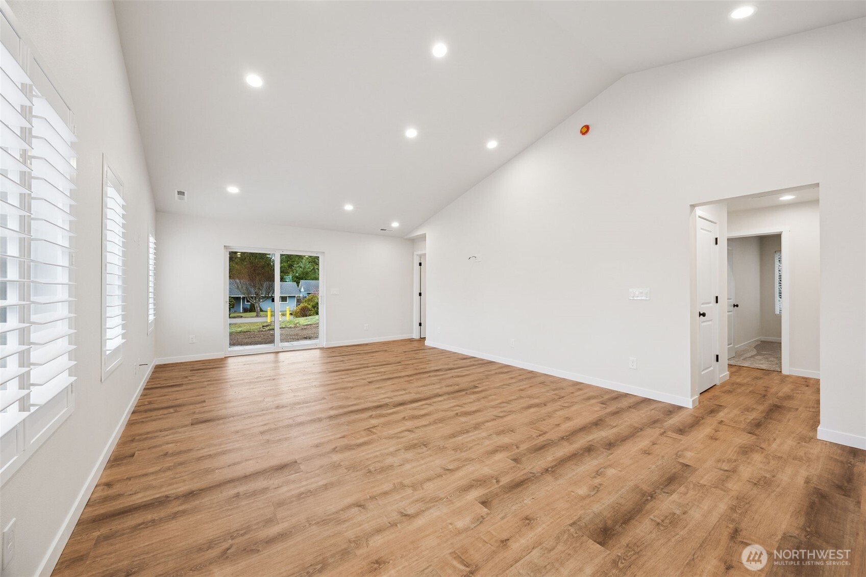 401 Pershing Avenue Carbonado, WA 98323 - Photo 5 of 38 a view of empty room with wooden floor and windows