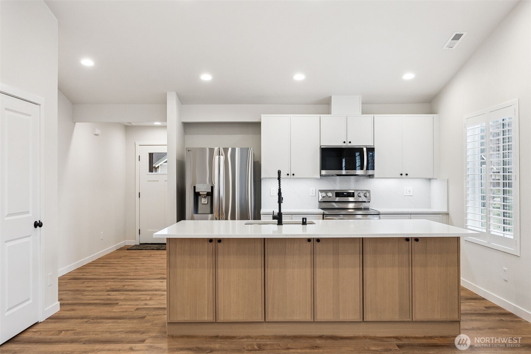 401 Pershing Avenue Carbonado, WA 98323 - Photo 10 of 38 a large kitchen with stainless steel appliances granite countertop a stove a sink and a refrigerator with wooden floor