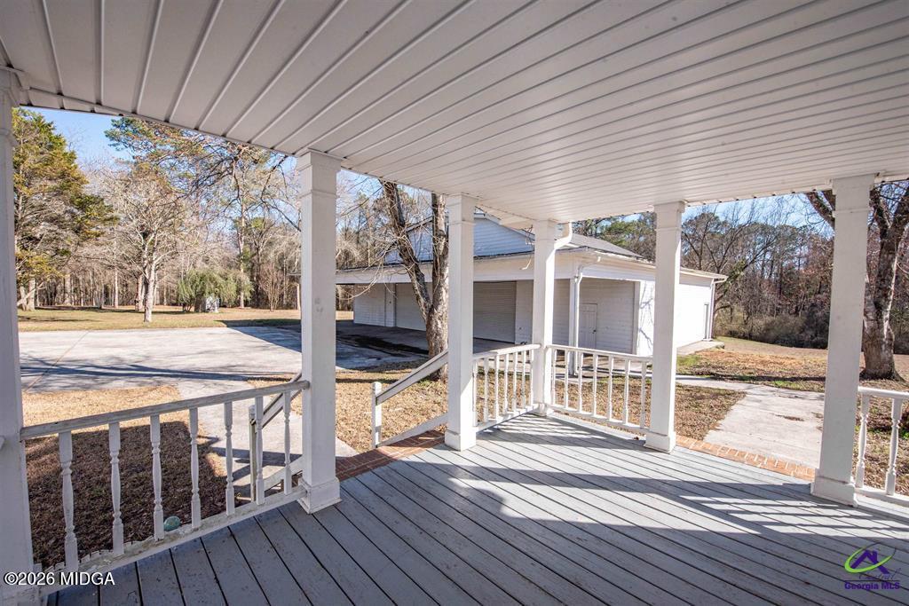 1441 Zenith Mill Road Roberta, GA 31078 - Photo 27 of 80 a view of a patio with wooden floor and iron stairs
