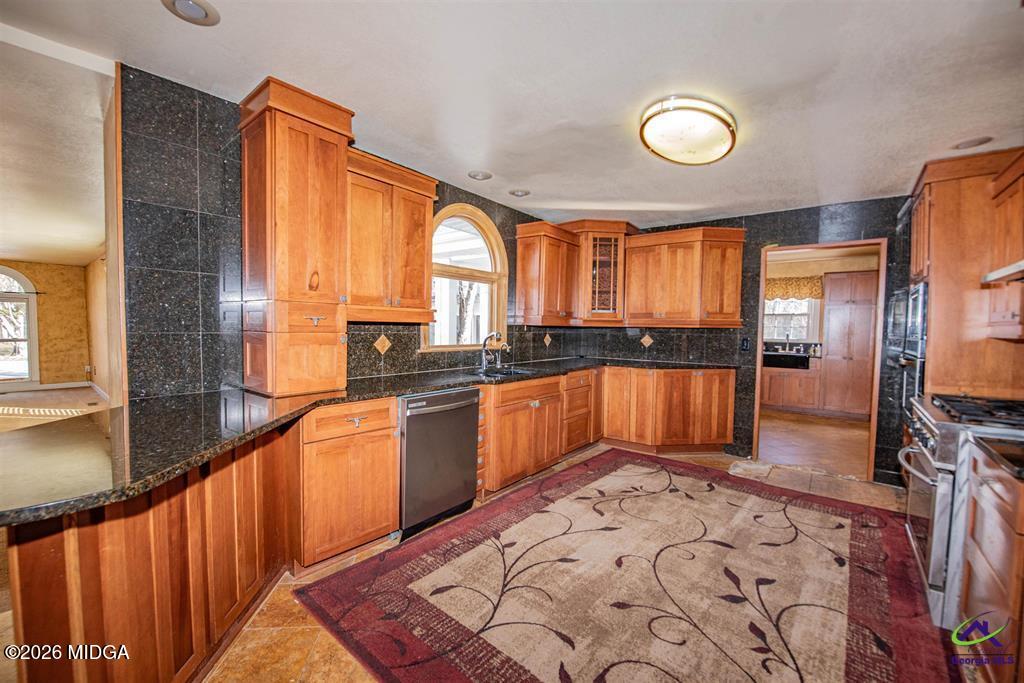 1441 Zenith Mill Road Roberta, GA 31078 - Photo 42 of 80 a kitchen with stainless steel appliances granite countertop a stove a sink and a refrigerator
