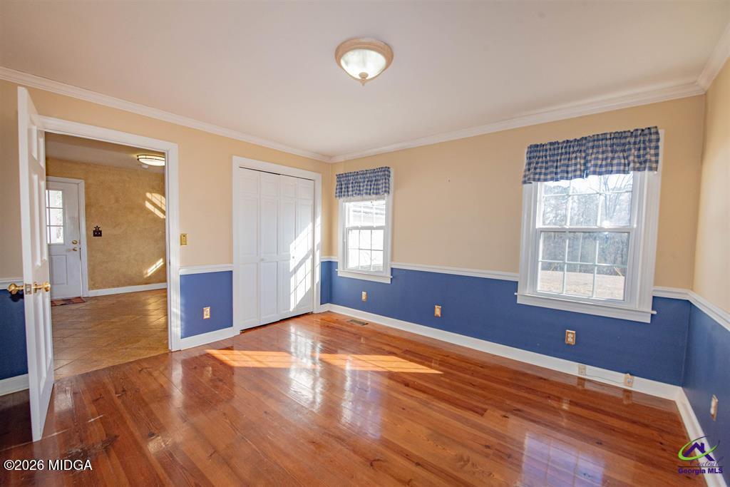 1441 Zenith Mill Road Roberta, GA 31078 - Photo 45 of 80 an empty room with wooden floor and windows