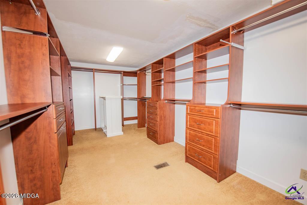 1441 Zenith Mill Road Roberta, GA 31078 - Photo 56 of 80 a view of walk in closet with clothes and shoes