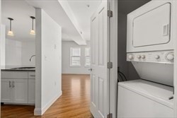 8 Dustin Street, Unit 103 Boston, MA 02135 - Photo 5 of 10 a bathroom with a sink a toilet and a mirror