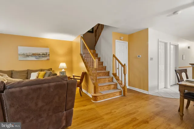 a view of a livingroom with furniture and stairs