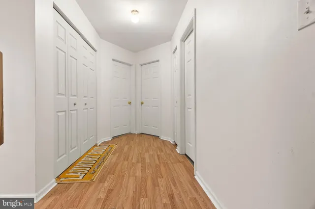 a view of a hallway with wooden floor
