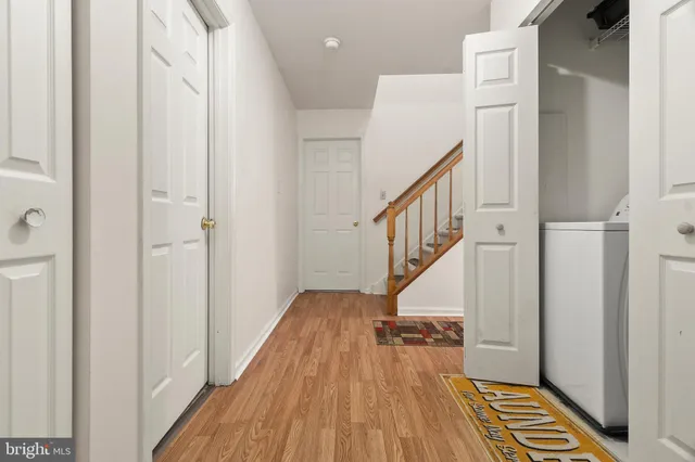 a view of hallway with wooden floor and staircase