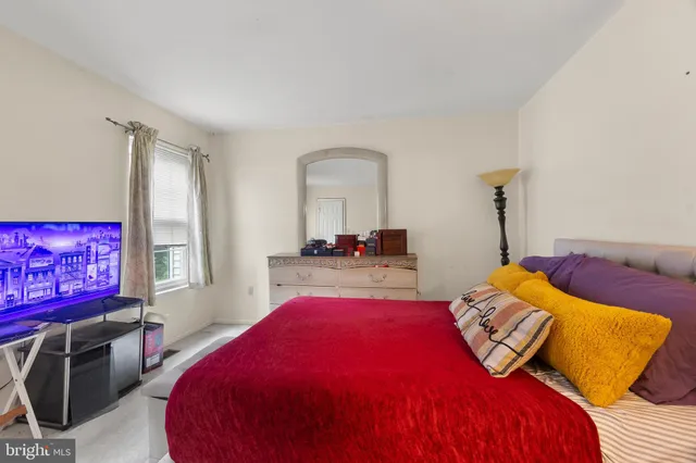 a bed room with a bed and a chair