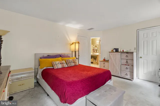 a bedroom with a bed and dresser