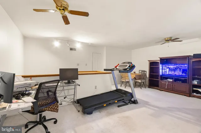 a room with gym equipment and a flat screen tv