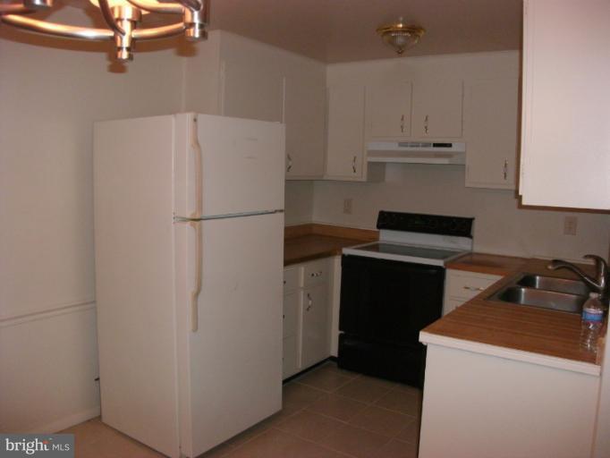 17670 Kohlhoss Road Poolesville, MD 20837 - Photo 11 of 12 a white refrigerator freezer sitting inside of a kitchen