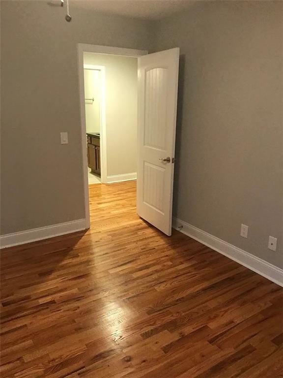 1071 Level Creek Road, Unit F Buford, GA 30518 - Photo 6 of 9 a view of wooden floor in an empty room