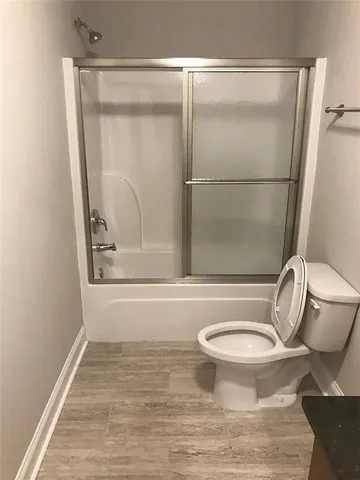 a bathroom with a toilet and a shower