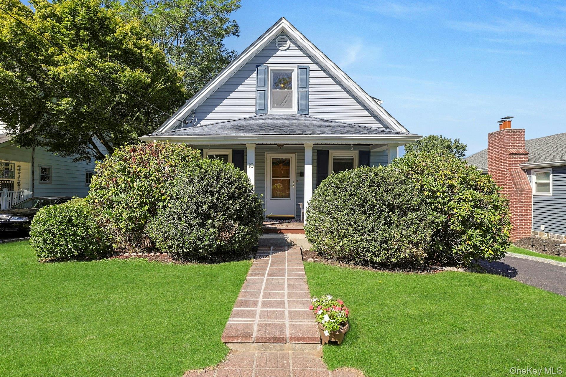 a front view of a house with a garden