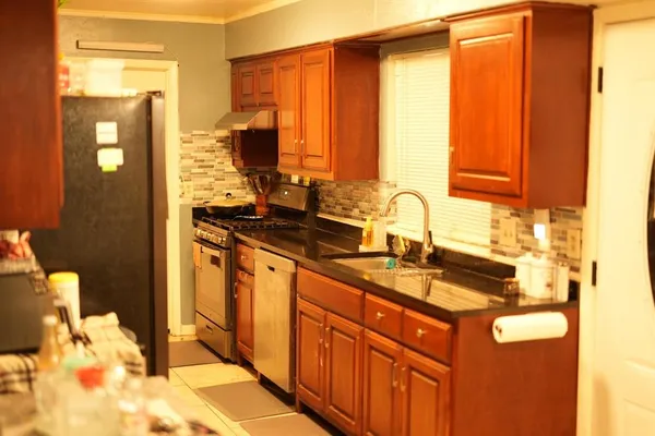 a kitchen with stainless steel appliances granite countertop a sink and cabinets
