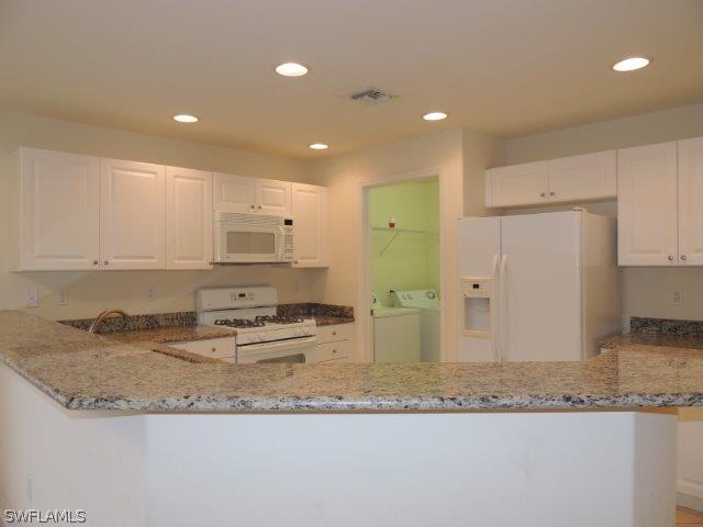 19680 Villa Rosa Loop Fort Myers, FL 33967 - Photo 3 of 14 a kitchen with kitchen island granite countertop a sink and cabinets