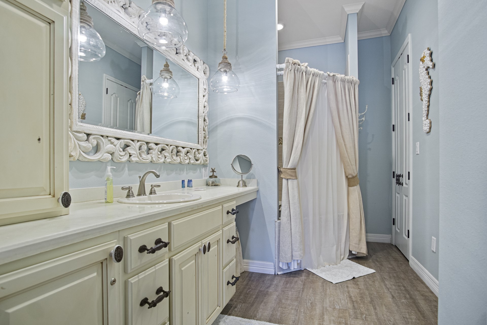 2573 Whitecap Crystal Beach, TX 77650 - Photo 12 of 50 a bathroom with a sink a mirror a vanity and a shower