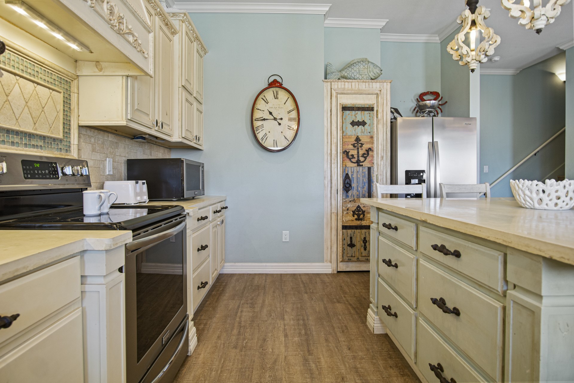 2573 Whitecap Crystal Beach, TX 77650 - Photo 24 of 50 a kitchen with cabinets stainless steel appliances and a clock