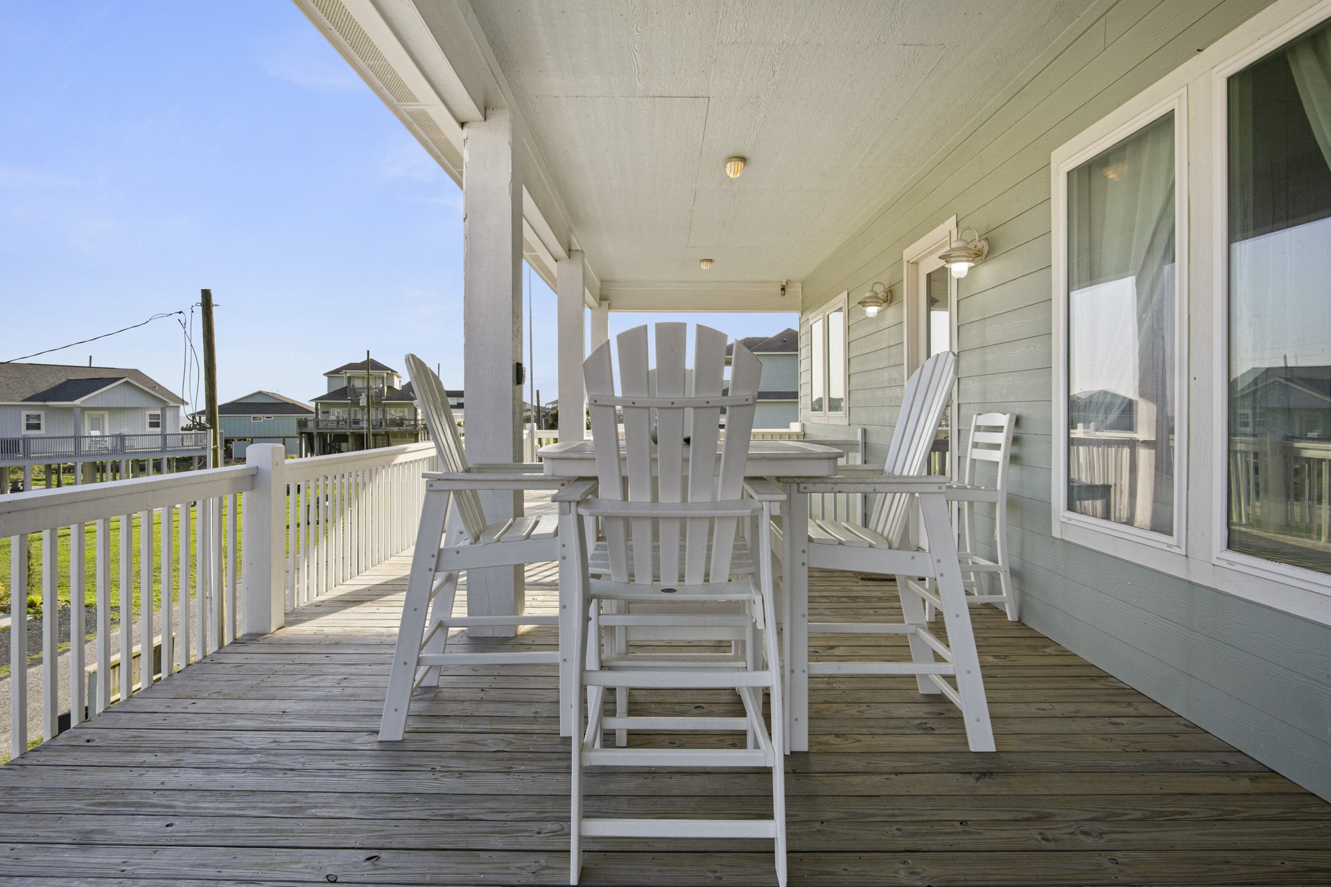 2573 Whitecap Crystal Beach, TX 77650 - Photo 43 of 50 a view of a balcony with chairs and wooden floor