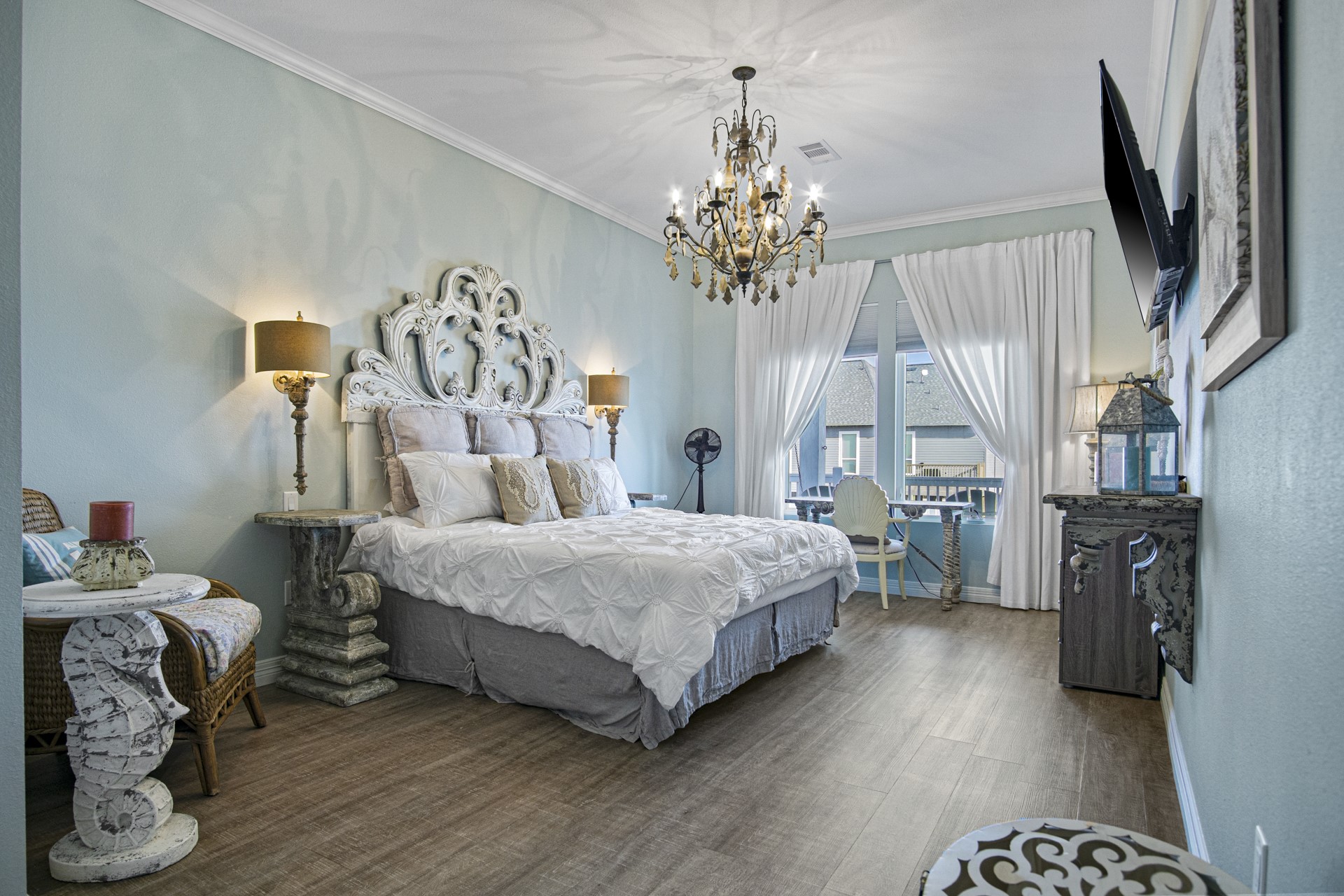 2573 Whitecap Crystal Beach, TX 77650 - Photo 10 of 50 a spacious bedroom with a bed and a chandelier