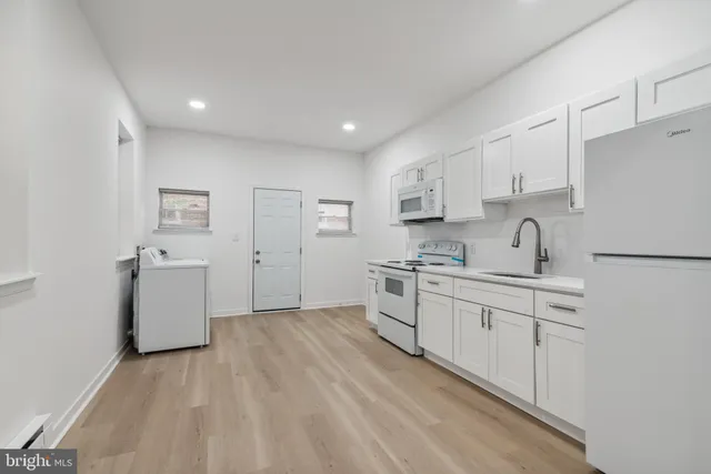 a kitchen with sink cabinets and wooden floor