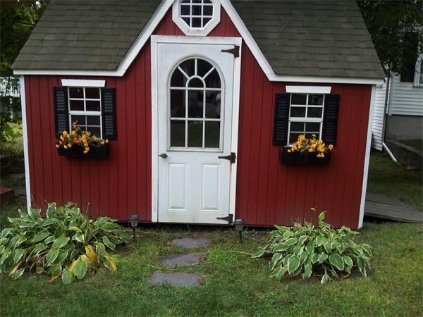 479 Main Street Hanson, MA 02341 - Photo 4 of 20 a view of a house with potted plants and a yard
