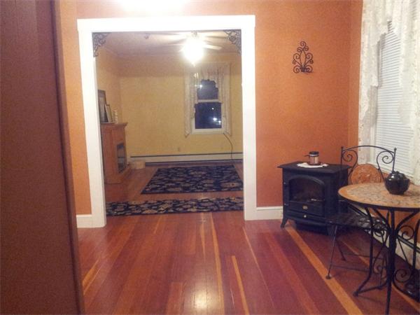 479 Main Street Hanson, MA 02341 - Photo 8 of 20 a view of a hallway with wooden floor and furniture
